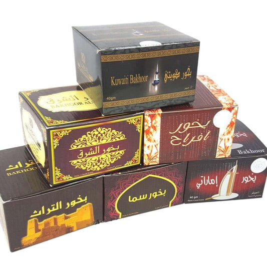Assorted boxed incense products with Arabic script on the packaging, displayed against a white background.