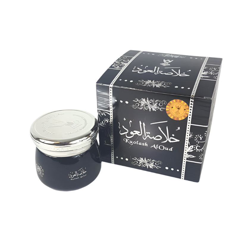 Dark blue jar with silver lid and decorative black box on a white background