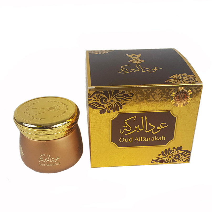 Gold and brown jar with decorative lid and matching box on a white background