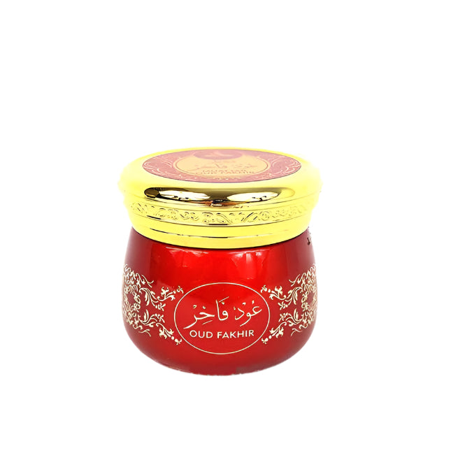 A jar of Muattar Oud Fakhir incense bakhoor by Hamidi Perfumes with a gold and red label, sealed with a lid.