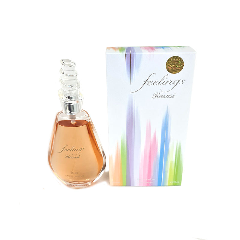 A bottle of 'Feelings Women 60ml EDP' by Rasasi alongside its packaging box. The bottle is tinted and the box is predominantly white with multicolored floral designs.
