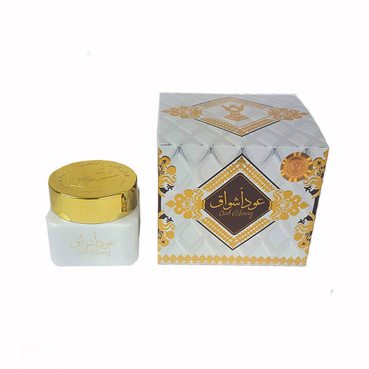 White jar with gold lid and decorative box on a white background