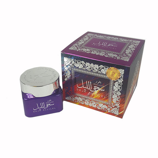 Purple jar with silver lid next to its decorative box on a white background