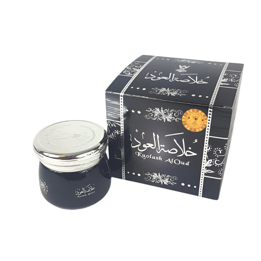 Dark blue jar with silver lid and decorative black box on a white background