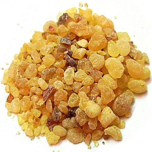 Heap of yellow resin crystals on a white background