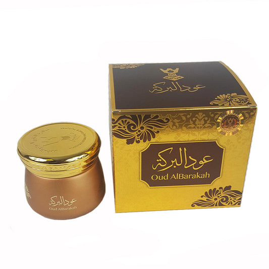 Gold and brown jar with decorative lid and matching box on a white background