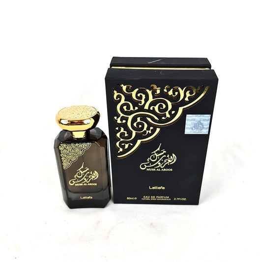 A black bottle of Lattafa Musk Al Aroos for Women EDP with a gold cap, alongside its packaged box. The box and bottle both feature gold and intricate designs.