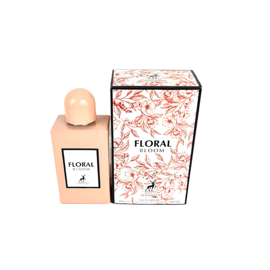 A bottle of Maison Alhambra Floral Bloom luxury perfume next to its packaging box, both featuring a floral design.